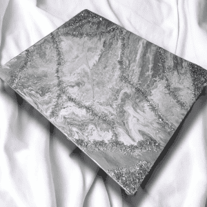 This mixed-media masterpiece utilizes a sophisticated palette of silver, gray, and white, brought to life through a rich array of textures