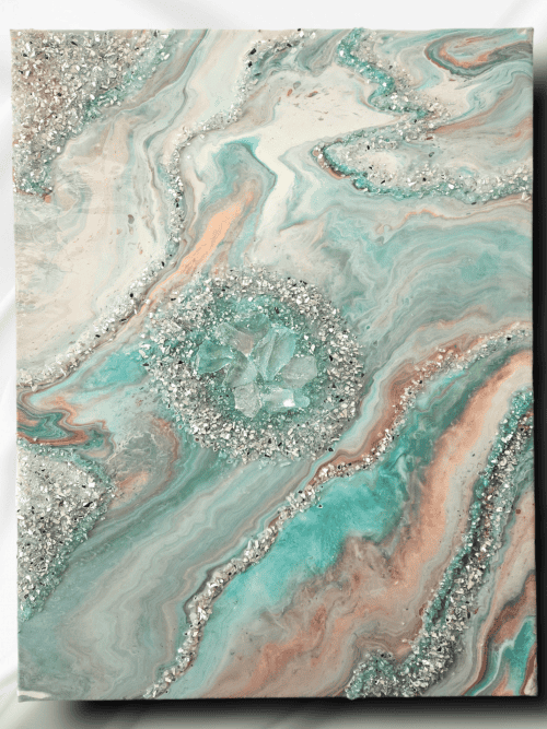 Image of the art piece "Coral Persuasion" by artist James Sanders. It features a combination of the colors teal, coral, white, and rose gold, embellished with resin, fire glass, and gem stones.