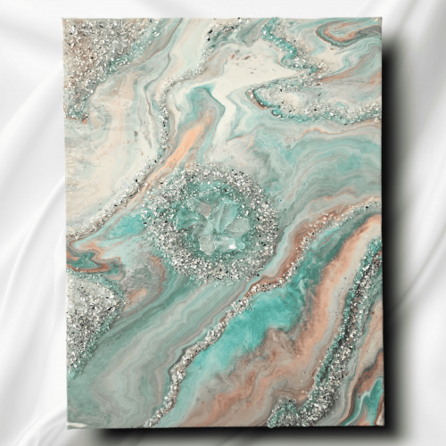 Image of the art piece "Coral Persuasion" by artist James Sanders. It features a combination of the colors teal, coral, white, and rose gold, embellished with resin, fire glass, and gem stones.
