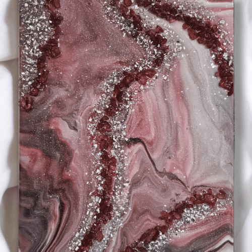 Image of the art piece "Crimson Correlation" by artist James Sanders. It features a combination of the crimson, silver, black, and white, embellished with resin, fire glass, and gem stones.