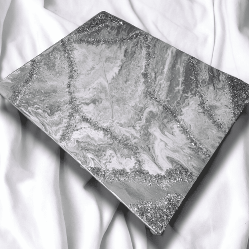 This beautiful piece of wall art features a subtle combinations of various shades of silver and gray embellished with cracked fire-glass. With the beautiful compliment of colors and texture, it is sure to be the eye catching piece to complete or build your space around